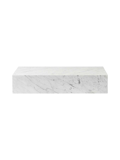 Front-facing view of the Plinth Grand, a rectangular plinth crafted from white Carrara marble with distinctive grey veins.