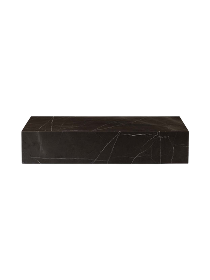 A front view of the Plinth Grand in Grey Kendzo, a low rectangular table made of dark marble with distinctive white veining.