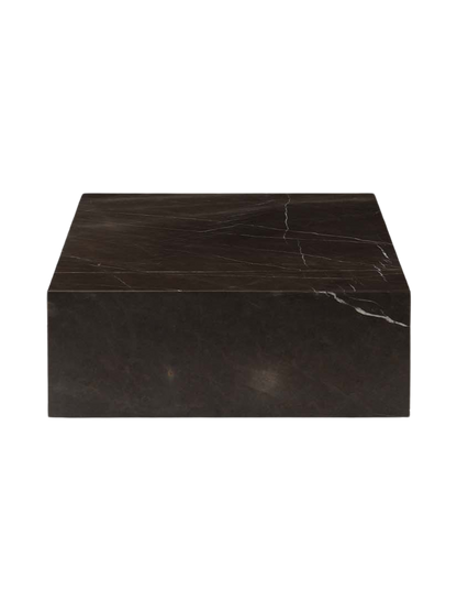 A side view of the low, rectangular Plinth Grand in dark Grey Kendzo marble, showing its white and grey veining.