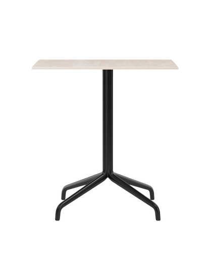 Front view of the Harbour Column Dining Table with a rectangular light-coloured top and a black, four-legged star base.