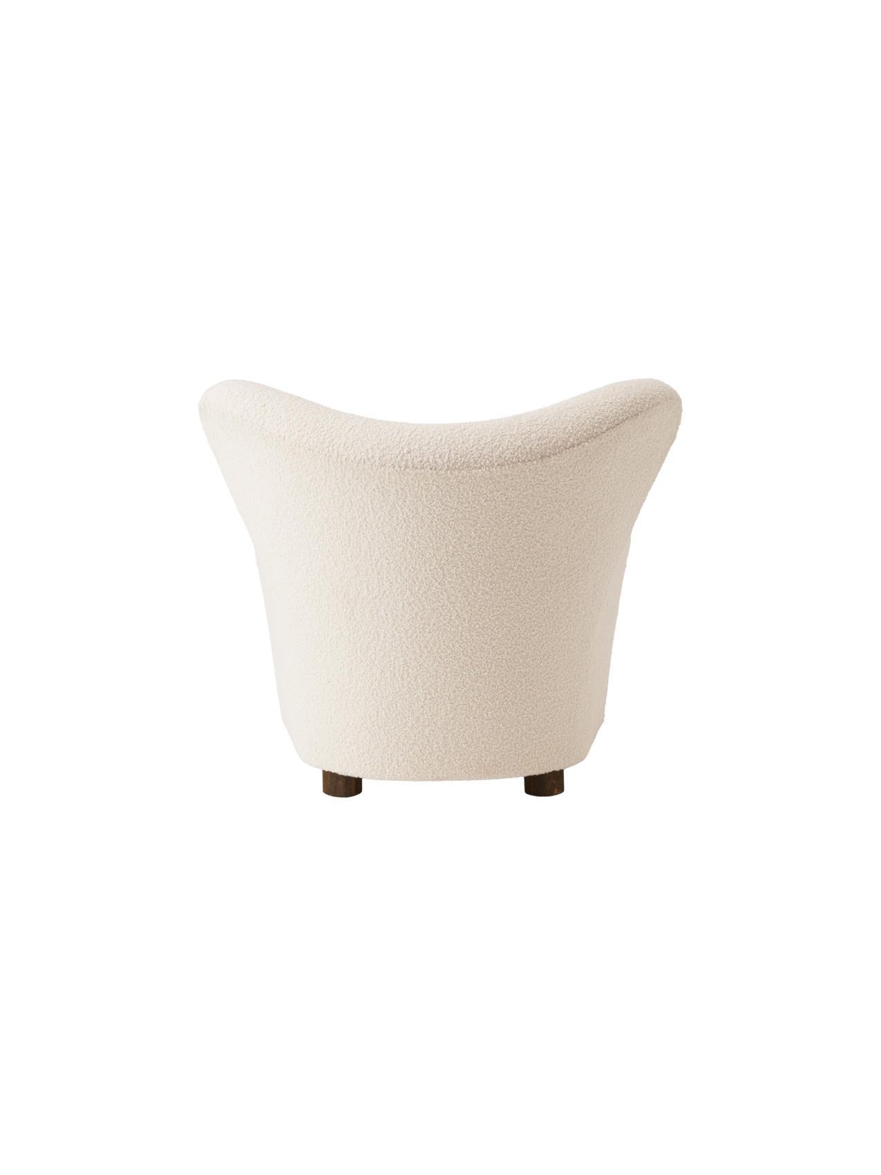 Back view of The Tired Man Lounge Chair. The chair has a high, curved back and is upholstered in a cream textured fabric.