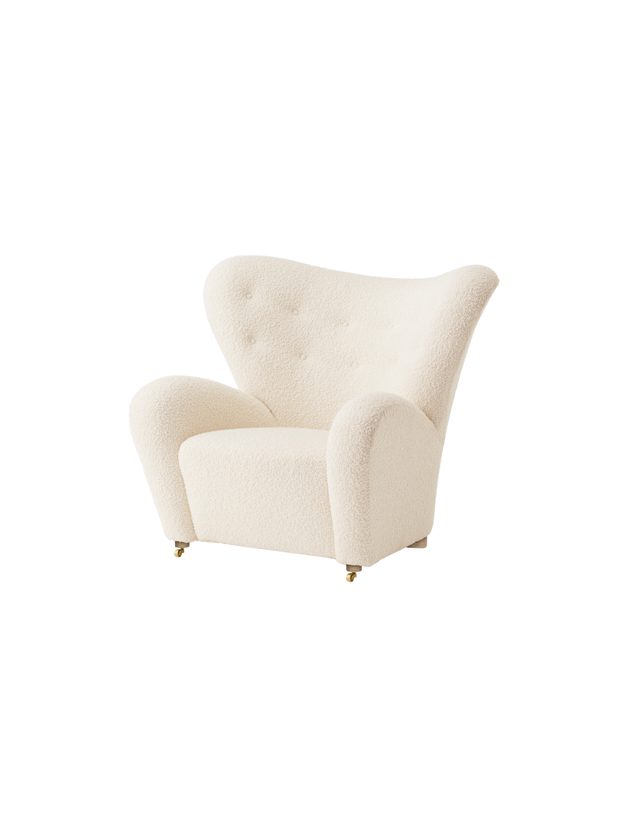 An angled view of The Tired Man Lounge Chair in a textured off-white textile, showing its curved high back and brass castors.