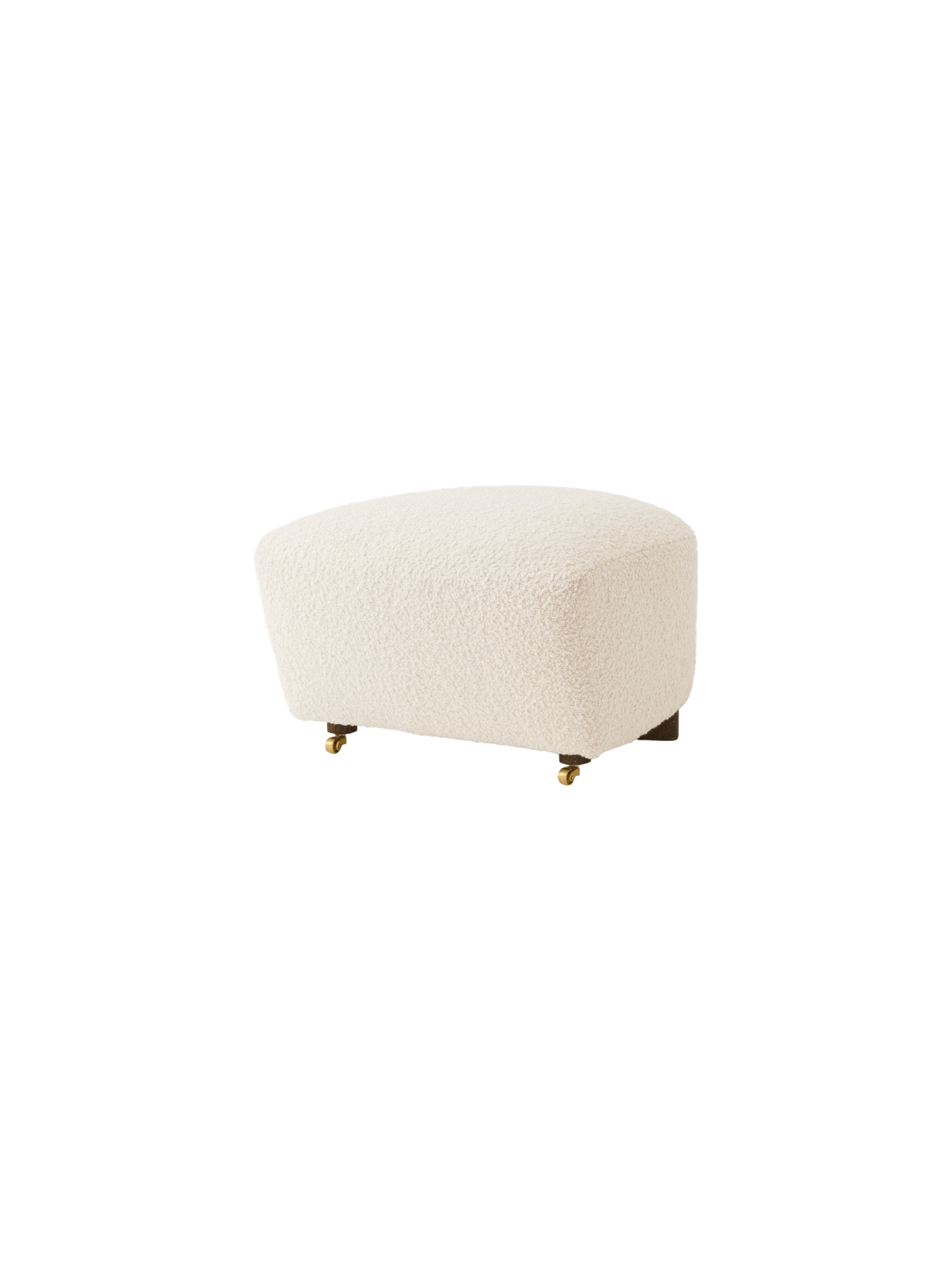 The Tired Man Ottoman in cream bouclé fabric, shown at an angle. It has dark wood legs with two brass casters at the front.