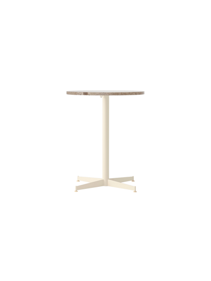 Front view of the Nook Dining Table with a round Kunis Breccia stone top and a slim, four-star base in an ivory finish.