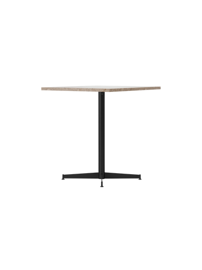 The Nook Dining Table, seen from the side, with a round Kunis Breccia stone top and a slender black four-star metal base.