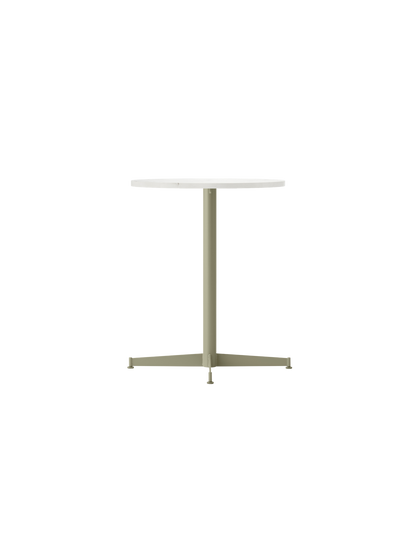 An angled view of the Nook Dining Table, featuring a round Estremoz marble top and a slim, four-star base in olive green.