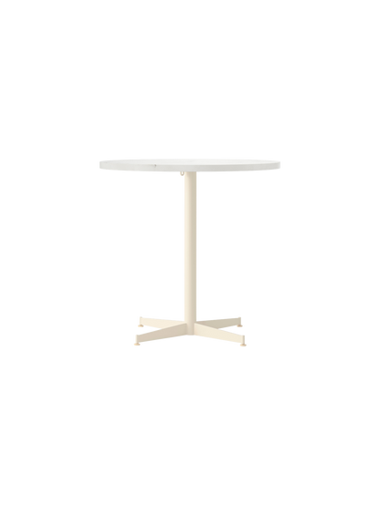 A front-on view of the Nook Dining Table, featuring a round, light-coloured stone top and an ivory powder-coated metal base.