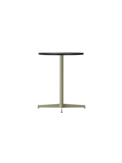An angled view of the Nook Dining Table, featuring a round charcoal linoleum top and a slim, olive-coloured four-star base.