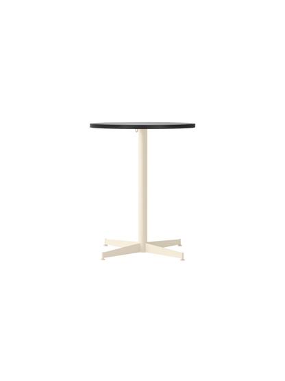 Front view of the Nook Dining Table with a round black oak top and an ivory powder-coated steel stem and four-star base.