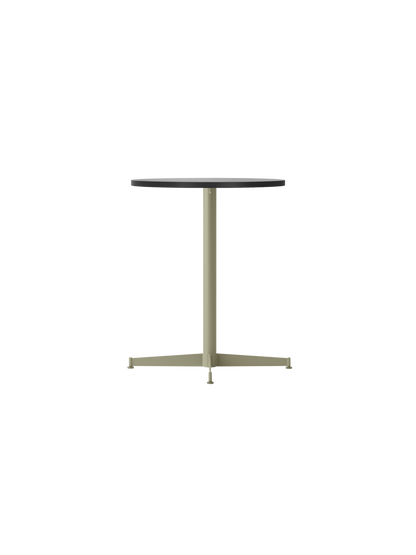 Angled view of the Nook Dining Table with a round black oak veneer top and an olive green powder-coated steel pedestal base.
