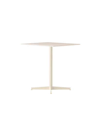 Angle view of the ivory Nook Dining Table, which has a square top, a single central stem, and a slim, four-star base.