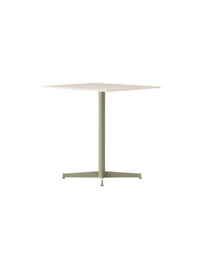 Angled view of the Nook Dining Table with a square, light stone top and a slim, olive green, four-star pedestal base.