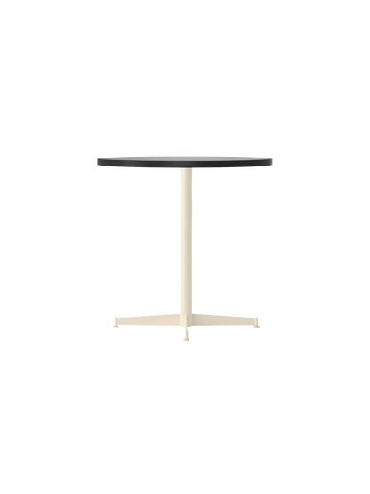 Angle view of the Nook Dining Table with a charcoal linoleum top and an ivory powder-coated steel four-star pedestal base.