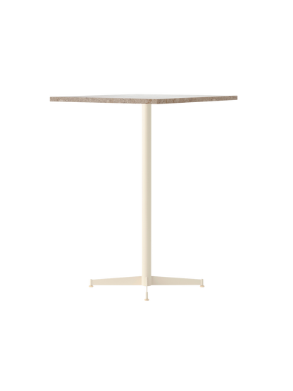 An angled view of the Nook Bar Table with a round Kunis Breccia stone top and a slender ivory-coloured pedestal base.