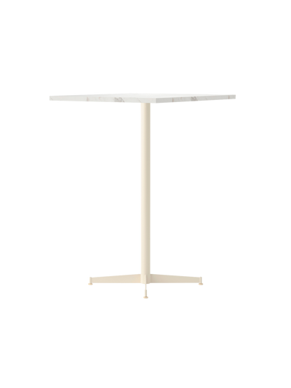 Nook Bar Table with an ivory powder-coated steel base and a round, white Estremoz marble tabletop, viewed from an angle.
