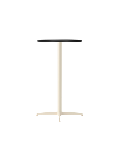 The Nook Bar Table with a round charcoal linoleum tabletop and a tall, ivory powder-coated steel base with four feet.