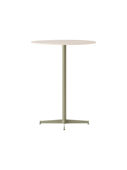 The Nook Bar Table shown at an angle, featuring a round, light-coloured tabletop and a tall pedestal base in an olive finish.