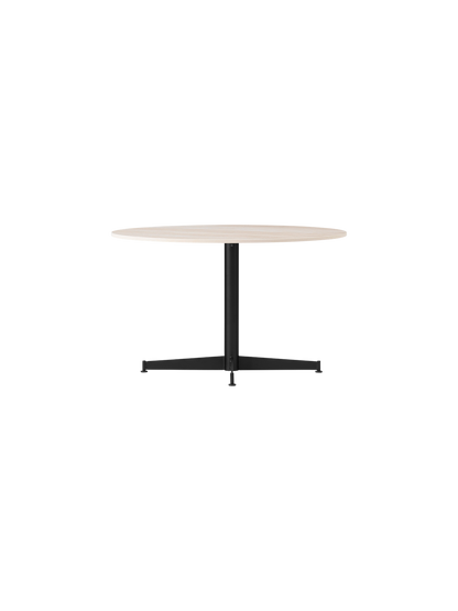 The Nook Lounge Table, shown at an angle, with a round, light-coloured stone top and a black four-star metal base.