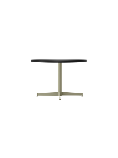 Side view of the Nook Lounge Table, featuring a round charcoal linoleum top and a slim, four-star base in an olive finish.