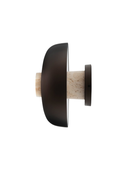 Detail side view of the turned-off Reverse Wall Lamp, showing the bronzed aluminium shade and the travertine stone base.