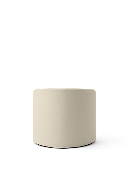 A cylindrical pouf upholstered in the textured, off-white Logan Jasmine fabric, an option for the Tearoom Lounge Chair.