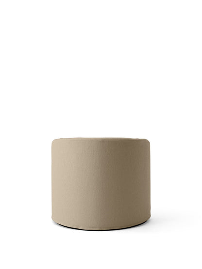 The Tearoom Pouf, a low, cylindrical seat upholstered in textured, sand-coloured Logan Sand fabric, on a white background.