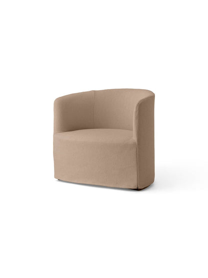 Angle view of the Tearoom Lounge Chair, with a curved back and loose cover in textured, light grey Logan Flint fabric.