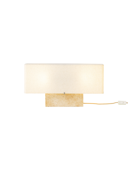Front view of the wide Nonna Table Lamp in Travertine, featuring an illuminated rectangular sand-coloured shade on a base.