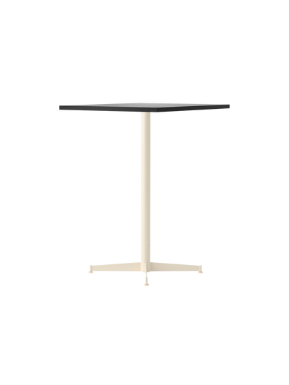 An angle view of the Nook Counter Table showing a rectangular stone-patterned top and slender, ivory-coloured pedestal base.