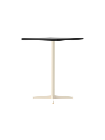 Angled view of the Nook Counter Table with a dark rectangular top and a contrasting ivory pedestal base.