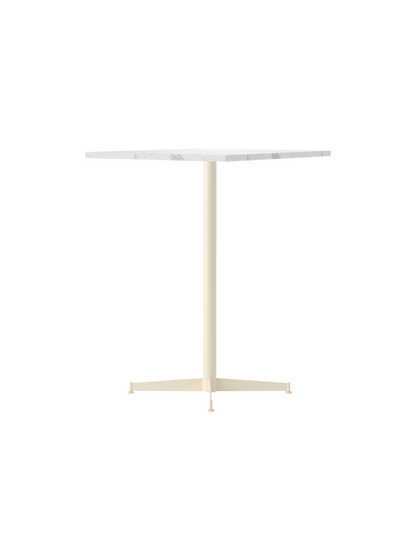 An angle view of the Nook Counter Table with a square white marble top and an ivory powder-coated steel pedestal base.