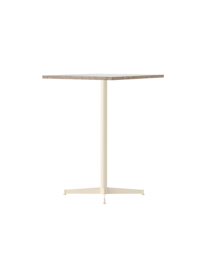 An angle view of the Nook Counter Table, featuring a textured Kunis Breccia stone top and a slender ivory pedestal base.