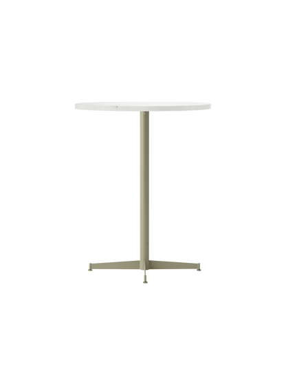 Angled shot of the Nook Counter Table. It has a round, light stone top and a slender olive base with a four-pronged foot.