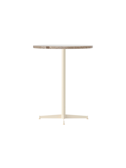 Angle view of the Nook Counter Table with a round Kunis Breccia stone top and an ivory powder-coated steel base.