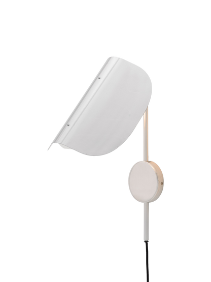 A polished aluminium Wing Wall Lamp, seen from an angle. The light is on, illuminating its distinct, folded wing-like shade.