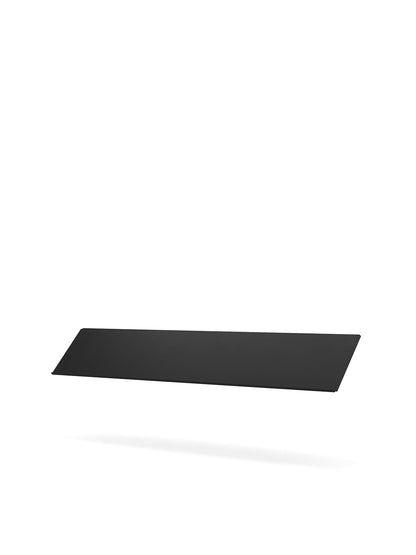 An angled, eye-level studio shot of the black Zet Storage System Magazine Shelf floating against a stark white background.
