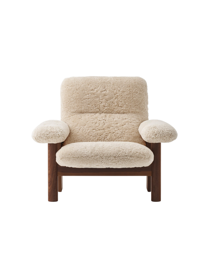 A front view of the Brasilia Lounge Chair with a high back, dark stained oak frame and thick, plush sheepskin upholstery.