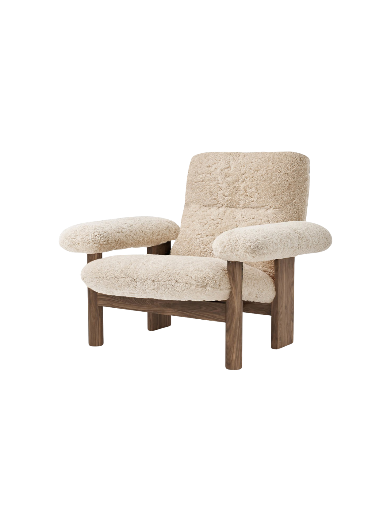 Angled view of the Brasilia Lounge Chair, featuring a high back and cushioned seat in natural sheepskin and a walnut frame.