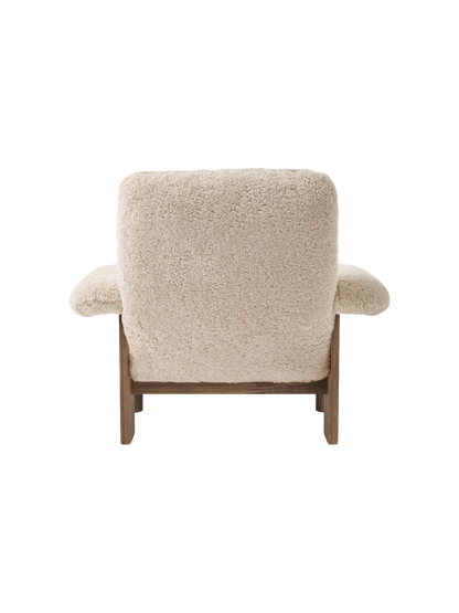 Back view of the Brasilia Lounge Chair, High Back, featuring cream sheepskin upholstery on a dark walnut frame.