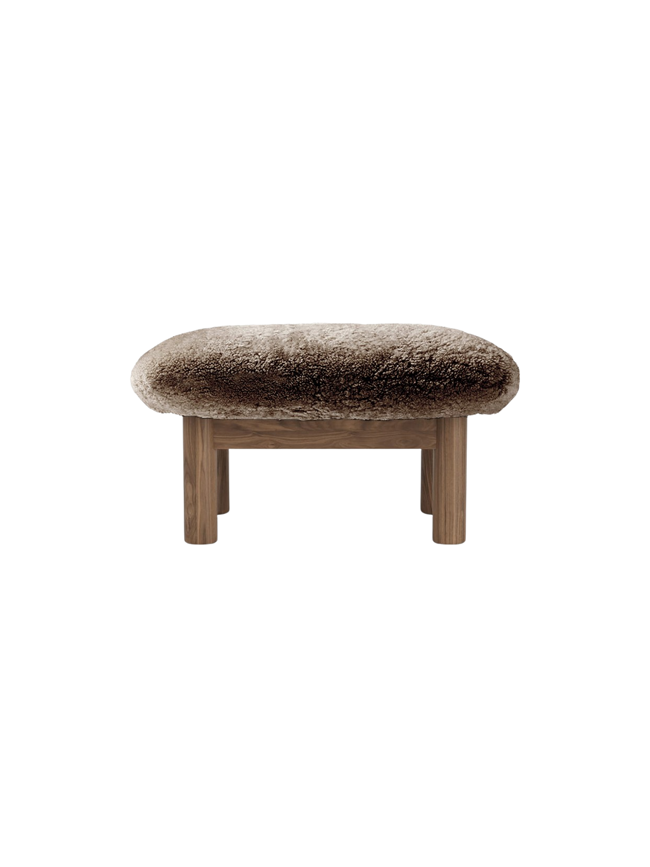 Brasilia Ottoman in Sheepskin, seen from the back. A thick, brown sheepskin seat on a wooden frame with four legs.