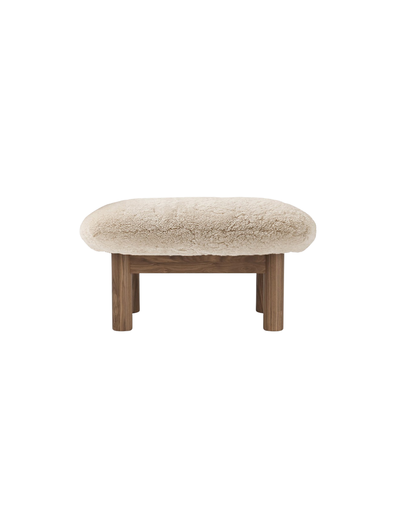 Back view of the Brasilia Ottoman, featuring a plush, cream sheepskin cushion on a wooden base with four cylindrical legs.