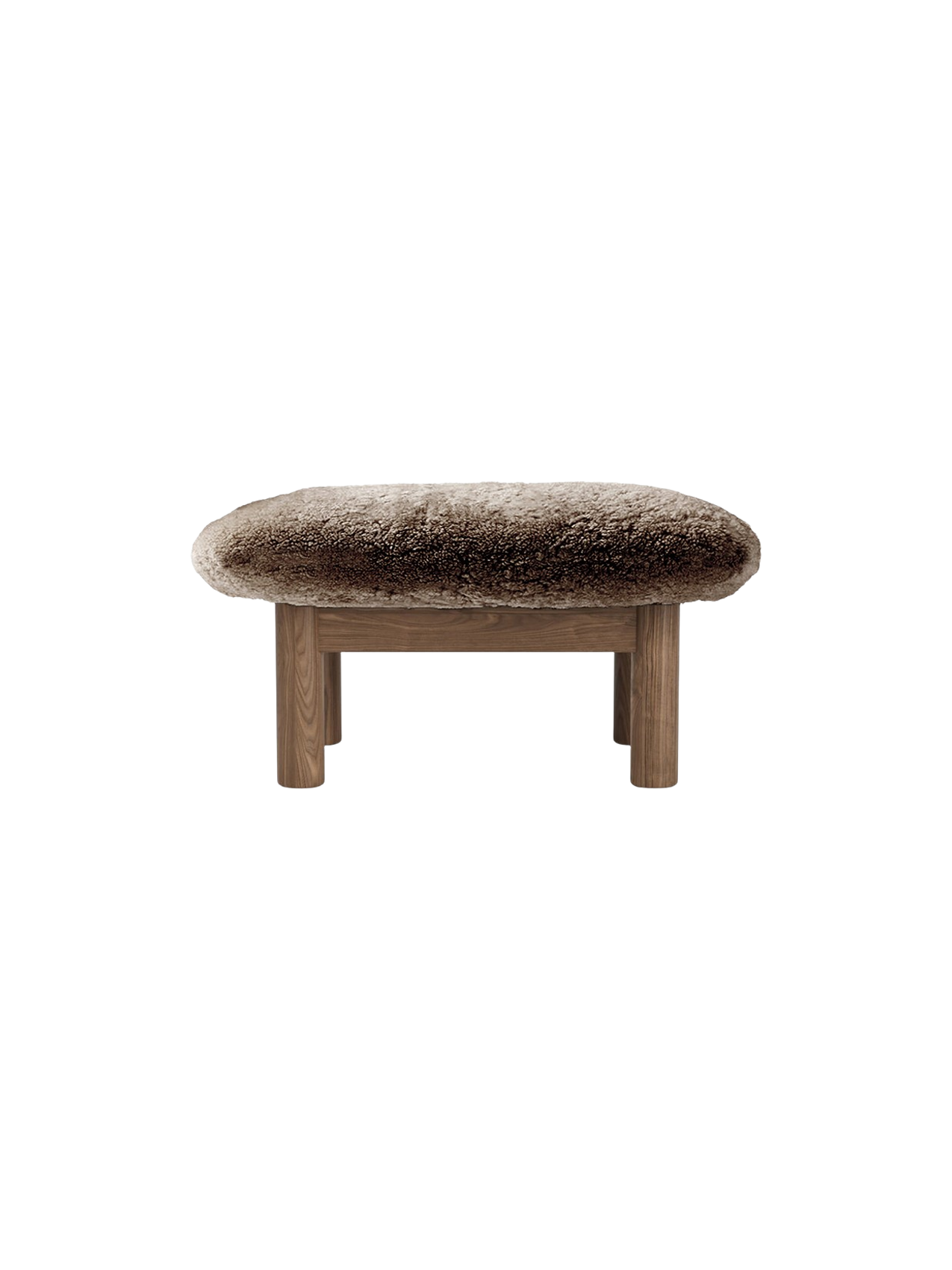 A front view of the Brasilia Ottoman, featuring a plush, brown sheepskin top and four robust, light-toned wooden legs.