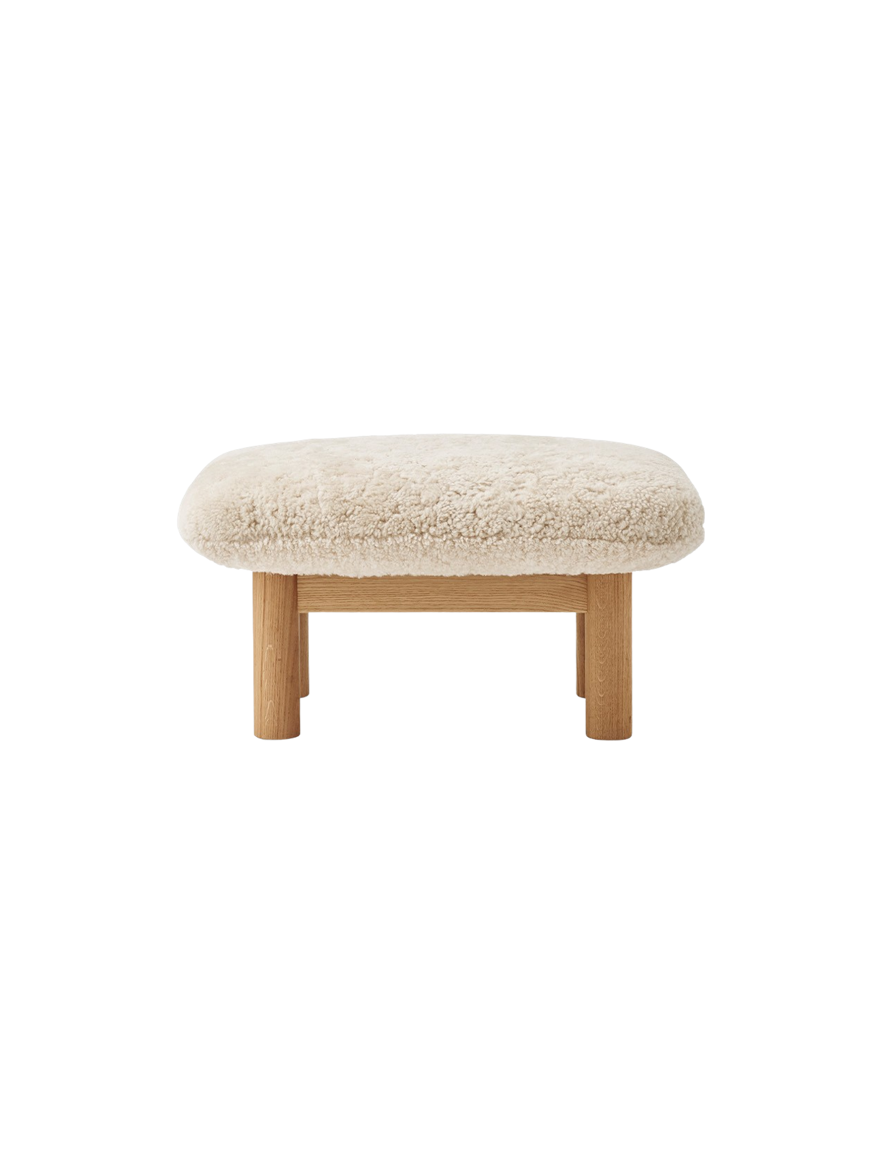 Front view of the Brasilia Lounge Ottoman, featuring a fluffy, off-white Sheepskin Nature cushion on a natural oak frame.