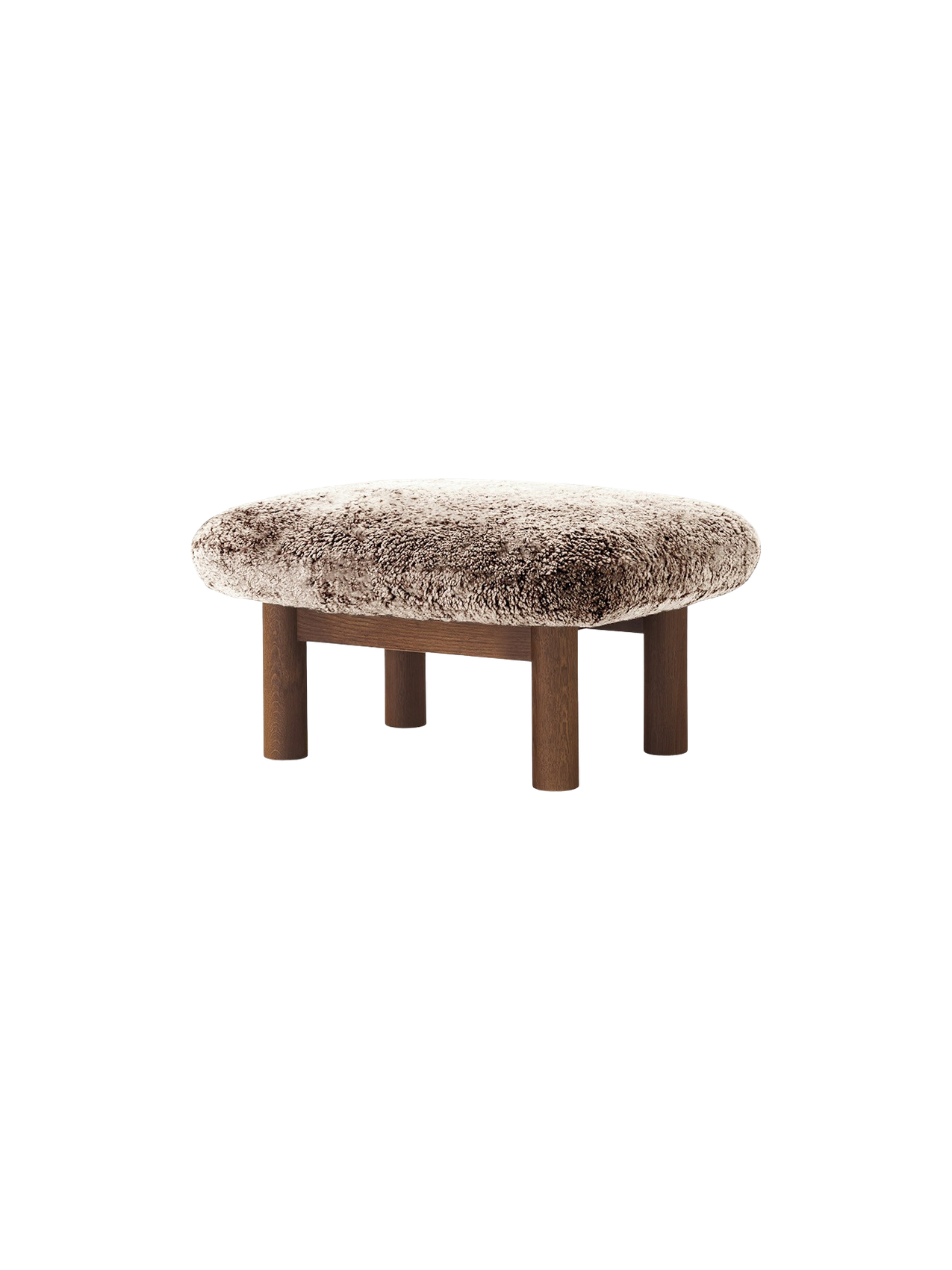 Brasilia Ottoman with a plush 'Root' sheepskin cushion and a dark stained oak frame with four robust, cylindrical legs.