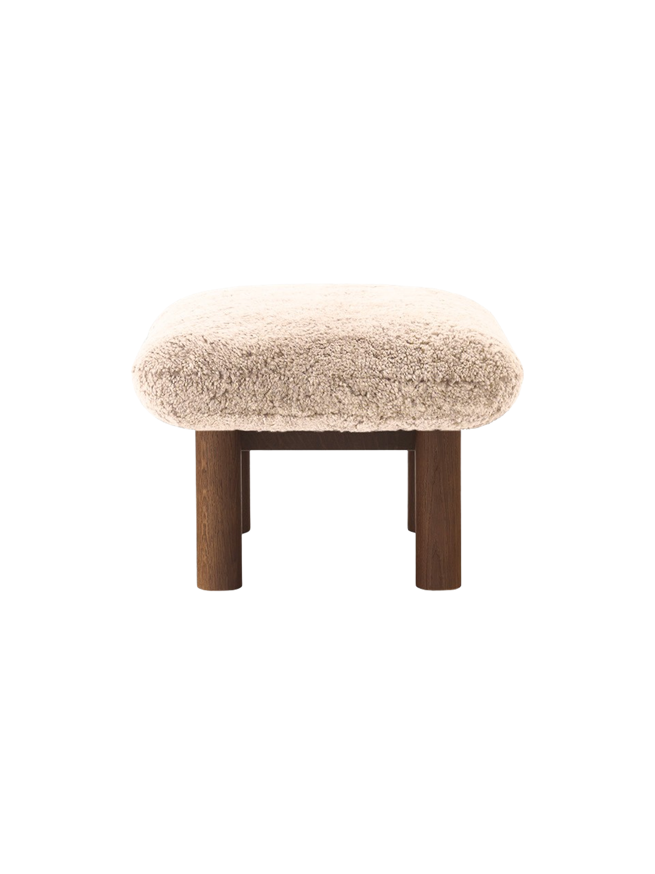 A side profile of the Brasilia Ottoman, showcasing its plush, light brown sheepskin seat atop a robust dark stained oak base.