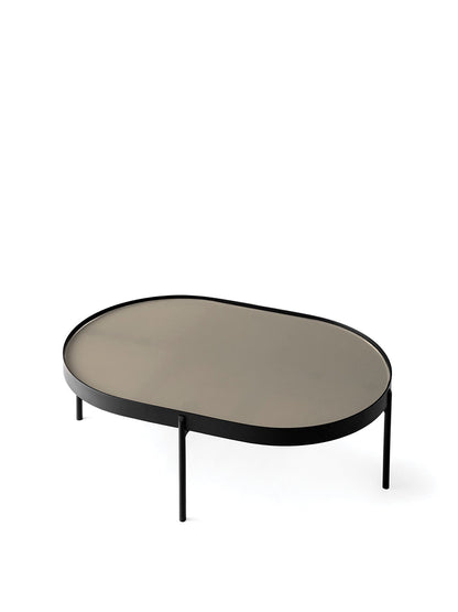 The NoNo Table, small, with an oval beige glass top and slender black powder-coated steel legs on a white background.