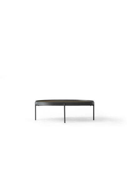 Front view of the large NoNo Table with an oval brown glass top and slender black metal frame and legs on a white background.