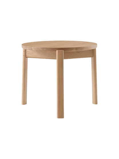Front view of the Passage Lounge Table in natural oak. The table features a round top and three solid, straight wooden legs.