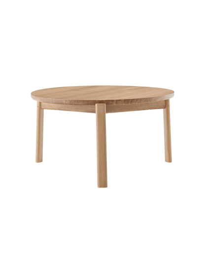 A front-facing image of the round Passage Lounge Table in natural oak, showcasing its circular top and four solid wood legs.
