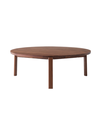 A front-facing image of the Passage Lounge Table in walnut. The round, wooden coffee table has four legs and a smooth finish.